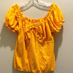 Wrapper women’s gold cotton top scooped neck with elastic frills and front bow.